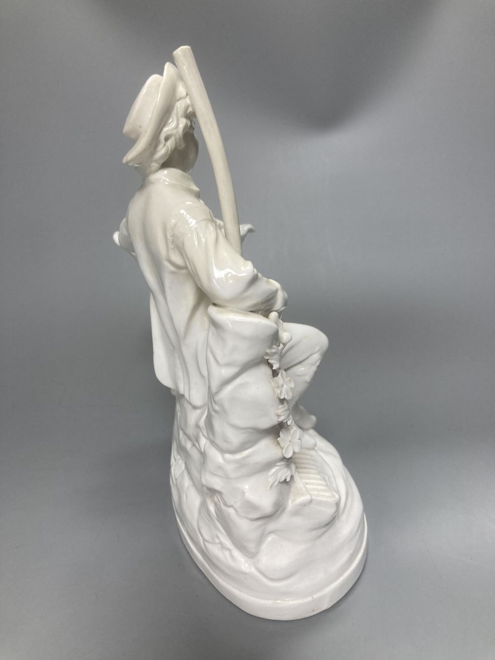 A pair of John Bevington bone china figures, gardener and female companion, 21.5cm